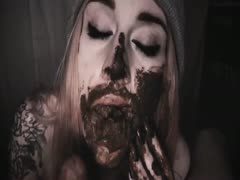 Goth bitch sucking a cock filled with shit